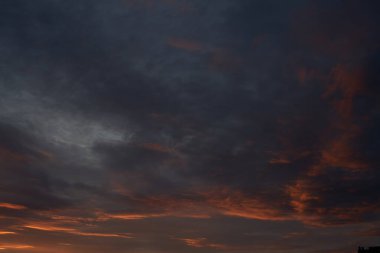 Gün batımında parlayan parlak ışık bulutlarıyla güzel bir akşam mavisi gökyüzü. Sıcak bir akşam. Nisan. Mayıs.