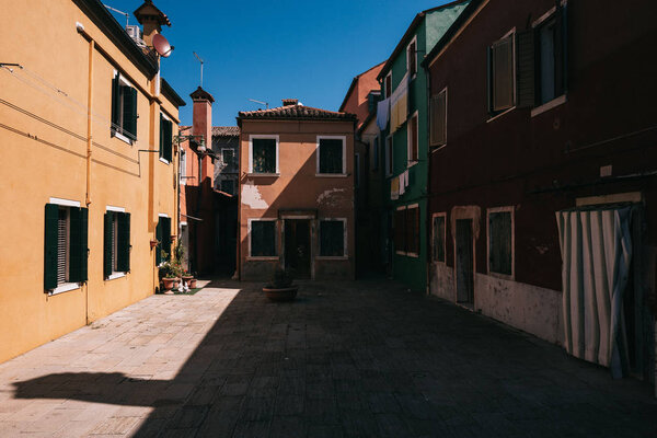 Italy, colorful houses on a small road in the old town of Murano