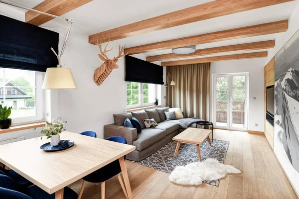 wooden interior of modern luxury apartment in the mountains, living room and kitchen