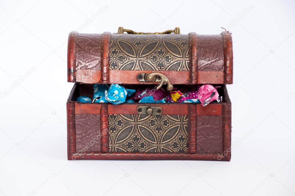 Treasure box chest full of bonbons, half opened
