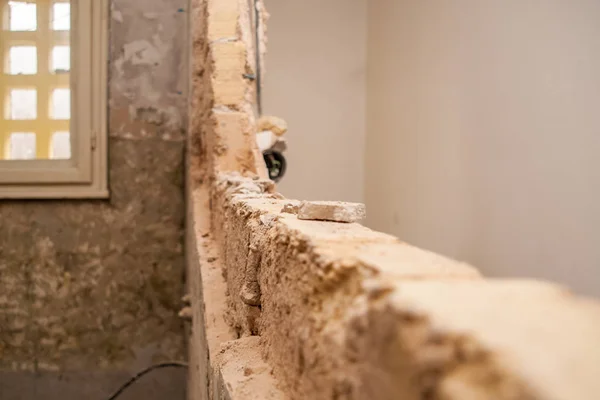 Flat renovation, demolition of the partition wall to create a si