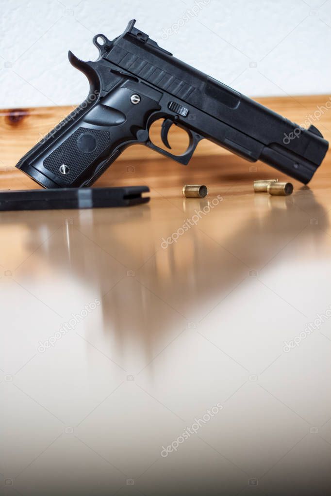 Gun on the floor, crime, the shell of the bullets next to the gu
