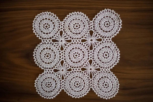 Handmade, white crochet, embroidery, on a wooden background, art