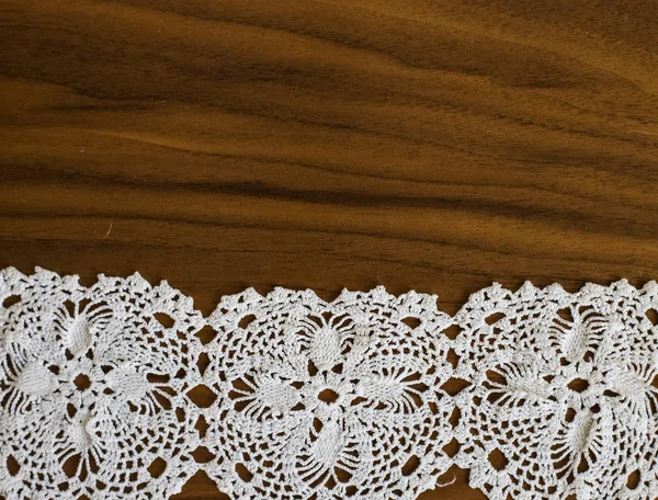 Handmade, white crochet, embroidery, on a wooden background, art