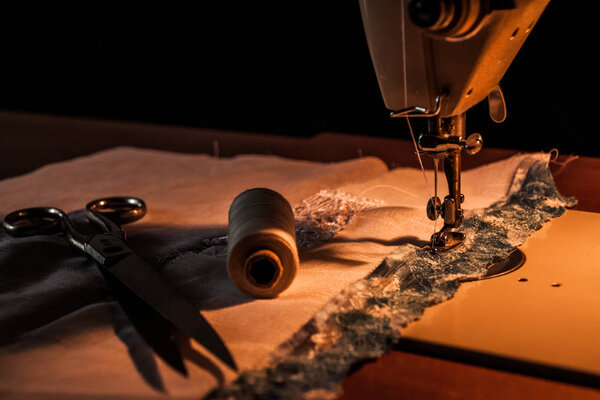 Sewing machine, sewing process, scissors and thread next to mach