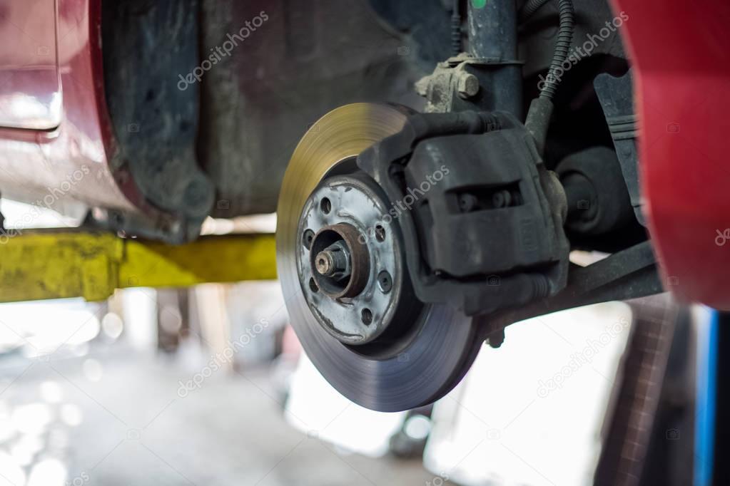 Car brake disc with no point, mechanic checks to see if everythi