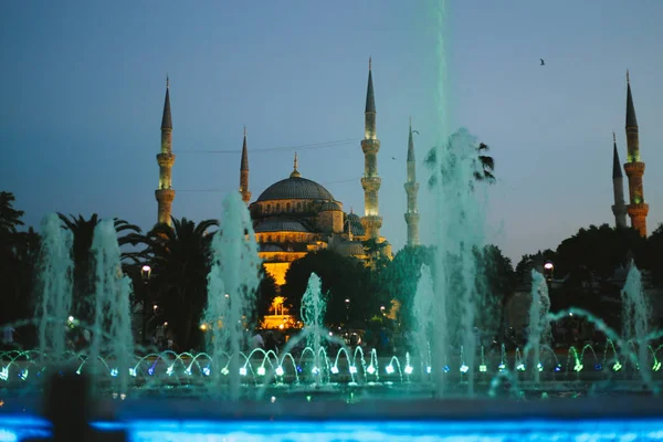 Mosque with blue fountain water as a postcard in sunset with min Stock Photo