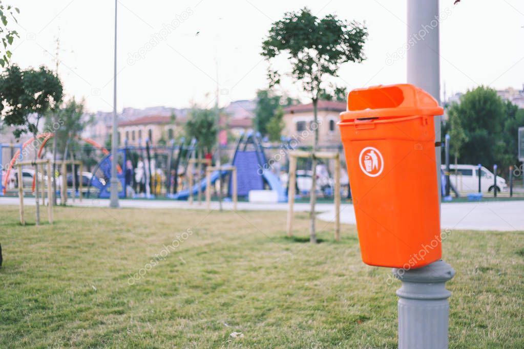 Garbage can, garbage disposal, park for children in the backgrou