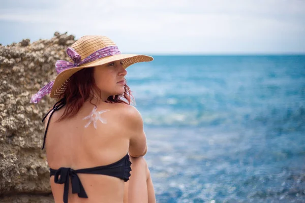 Une jeune fille sur une plage avec un chapeau, soleil et jouit du soleil, sur t — Photo