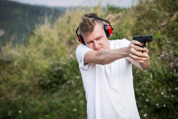 Young handsome blonde guy training policeman special forces shoo