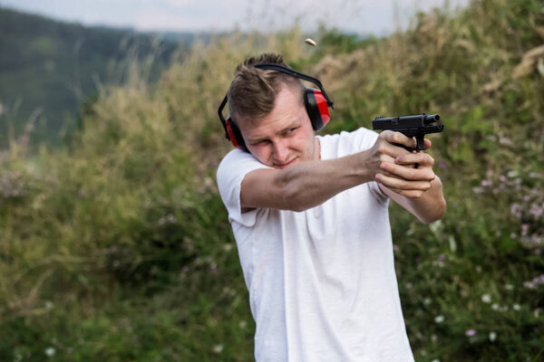 Young handsome blonde guy training policeman special forces shoo