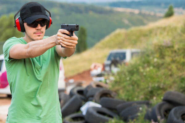 Policeman firmly aiming at the criminal enemy target with the pi