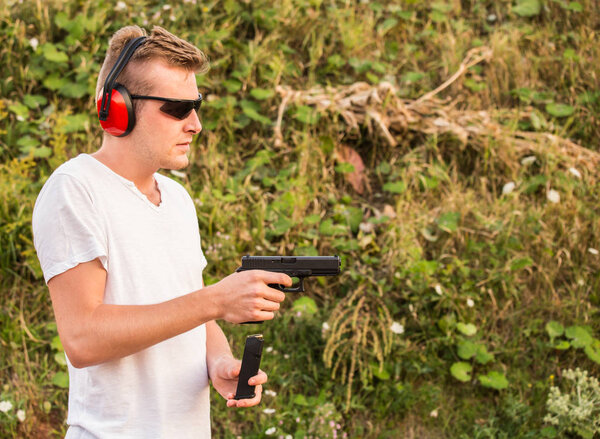 Handsome young blonde guy training on the battlefield and changi