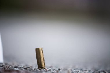 Bullet shell on the ground from the pistol. Crime scene investig clipart