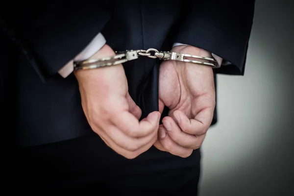 Businessman handcuffed for corruption, money laundering, tax eva — Stock Photo, Image