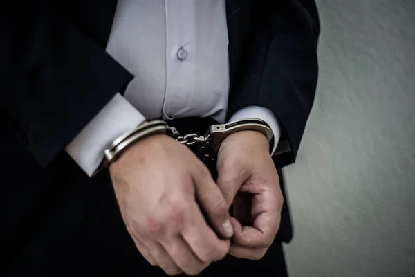 A businessman caught with handcuffs on his stomach for corruptio — Stock Photo, Image