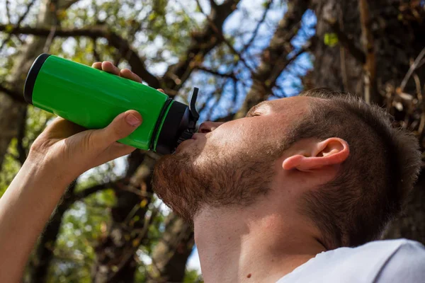 Фитнес-человек, после бега на природе, пьет свой протеин из — стоковое фото