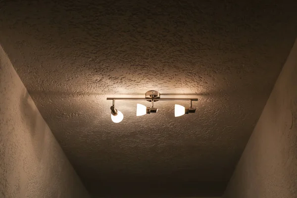 Luster on the ceiling with three bulbs — Stock Photo, Image