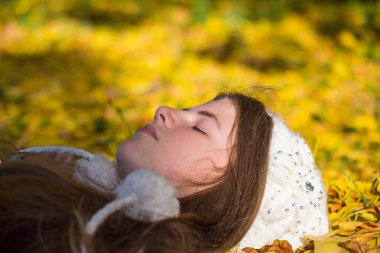 Genç sarışın kız sonbahar, altın sarı fo güneşli bir günde sahiptir