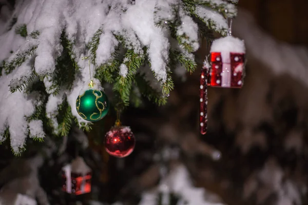 Christmas decorations on a fir tree, with snowflakes, mild light — Stock Photo, Image