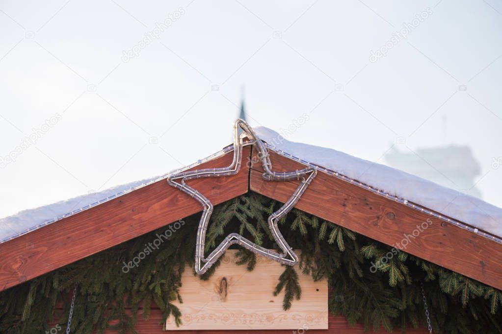 Christmas decoration, on the roof of the house a silver star, be