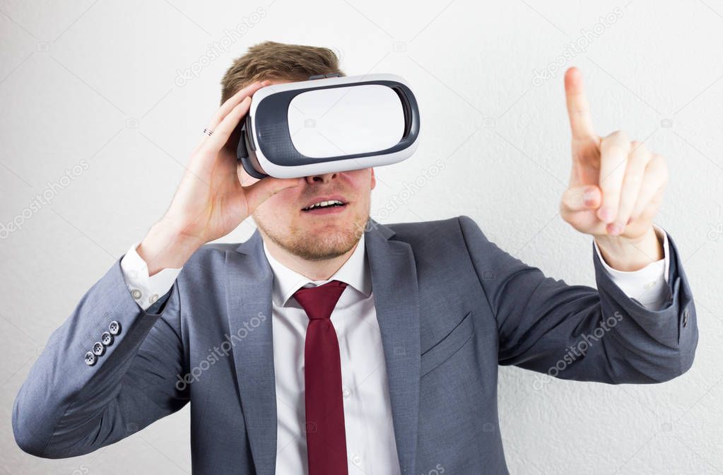 A businessman in a suit, with virtual reality glasses on his eye