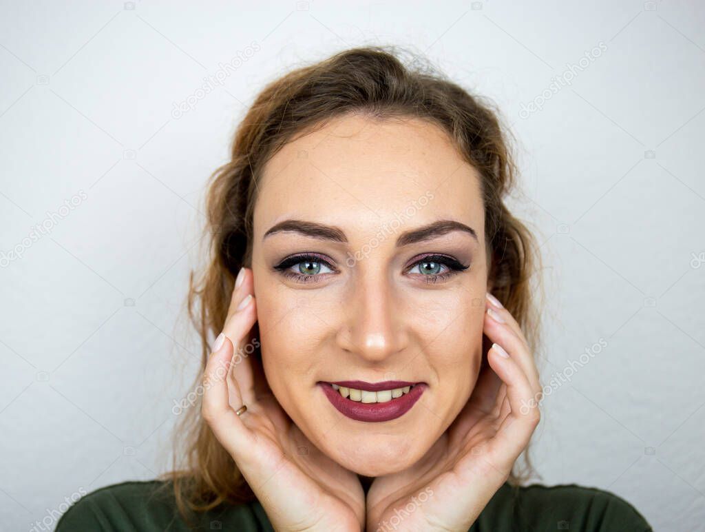 Portrait, beautiful girl, make-up, with smile posing on white background, makeup, powder, eye shadow, mascara, lipstick, eyeshadow