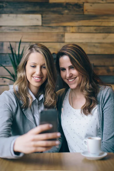 Masada oturan ve smartphone kullanarak kızlar