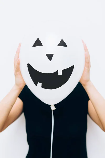 Gril hiding face with balloon — Stock Photo, Image