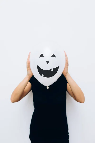 Gril hiding face with balloon — Stock Photo, Image