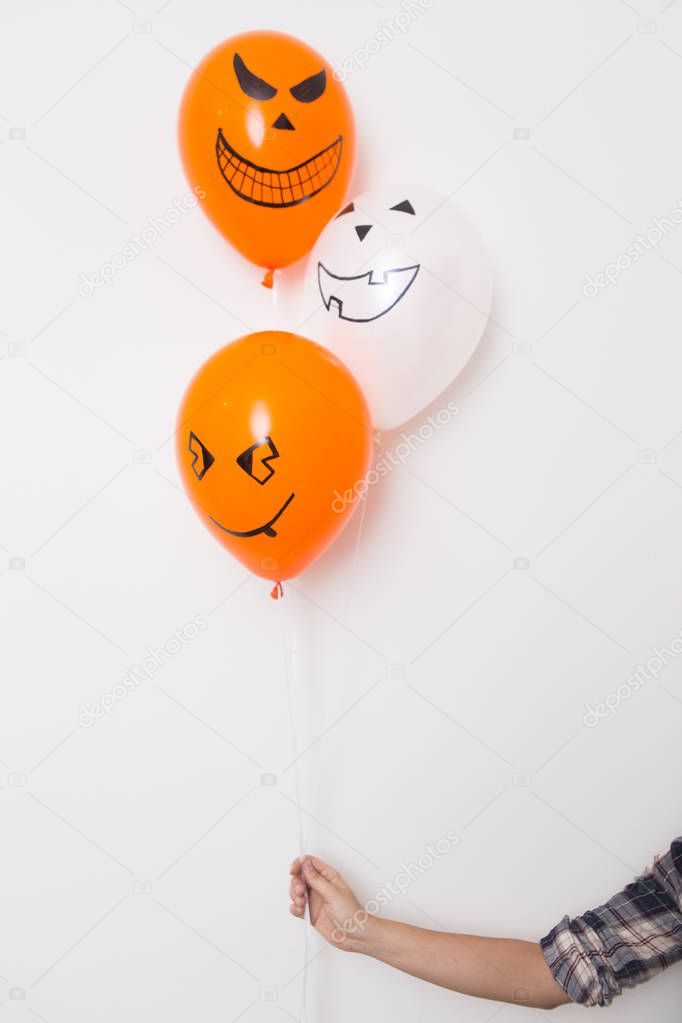 Halloween decoration of colored balloons with grins