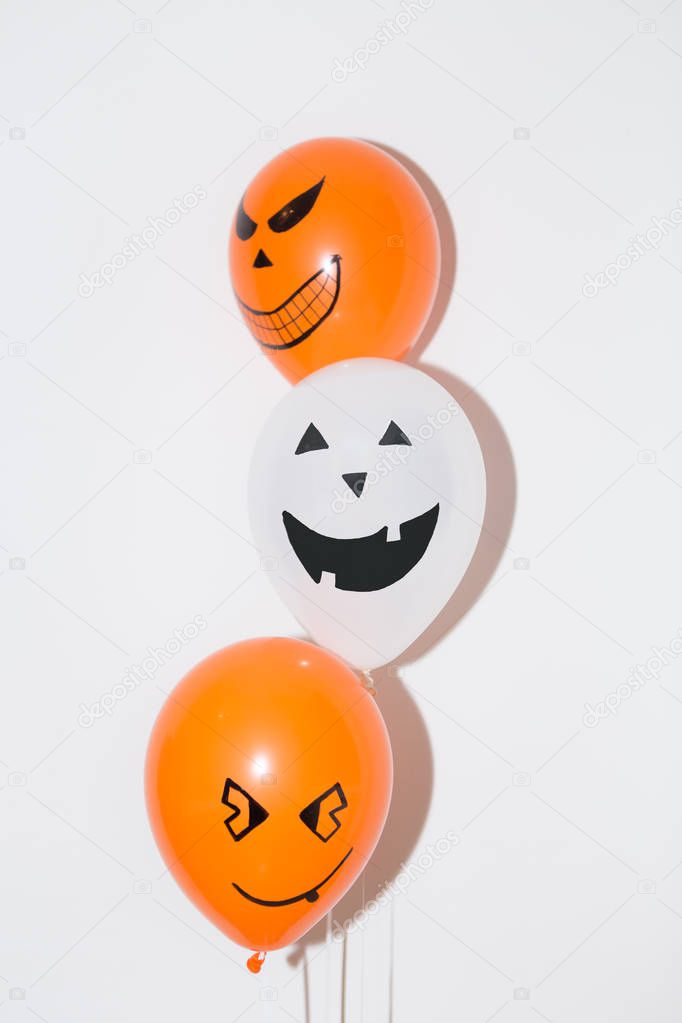 Halloween decoration of colored balloons with grins
