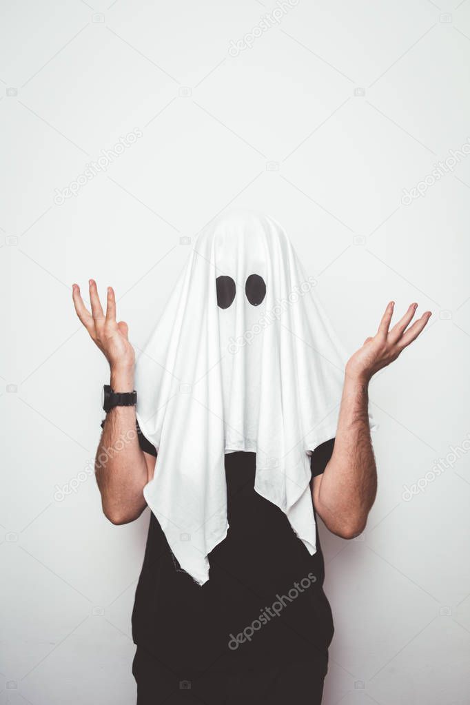 Man hiding face with white sheet