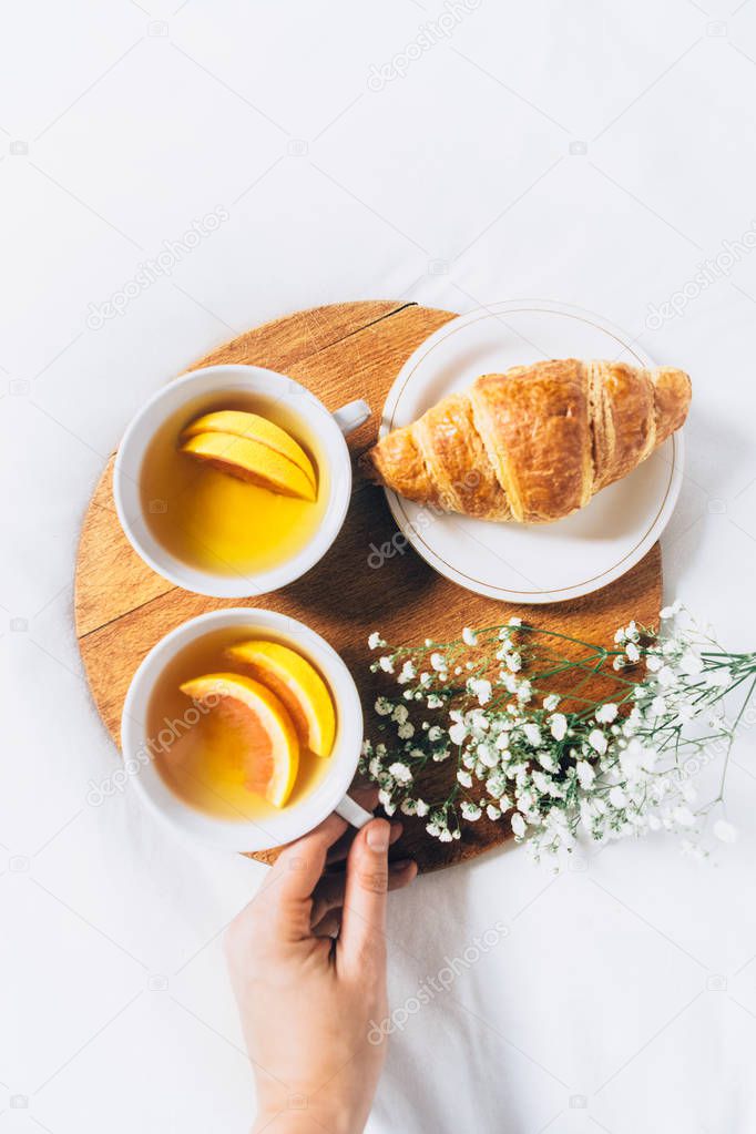 tea with lemon and croissant 