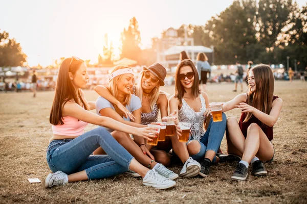 happy girlfriends enjoying start of the weekend on music festival