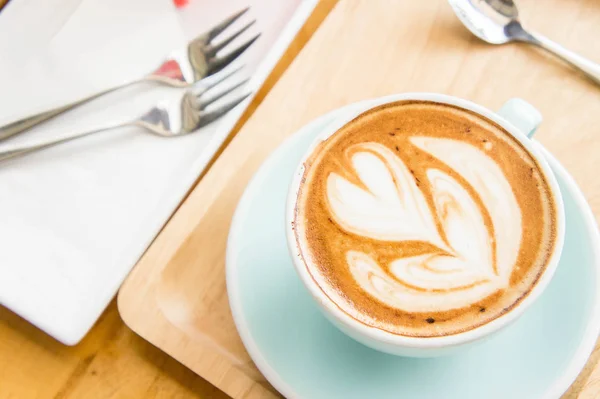 coffee heart cup and cake on wood table in coffe shop cafe