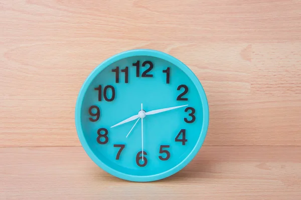 Green clock on wood background , Clock to tell time Create a plan to manage