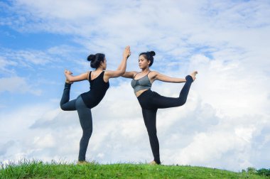 Kadın pratik yoga dinlenmek doğa ve mavi gökyüzü arka plan