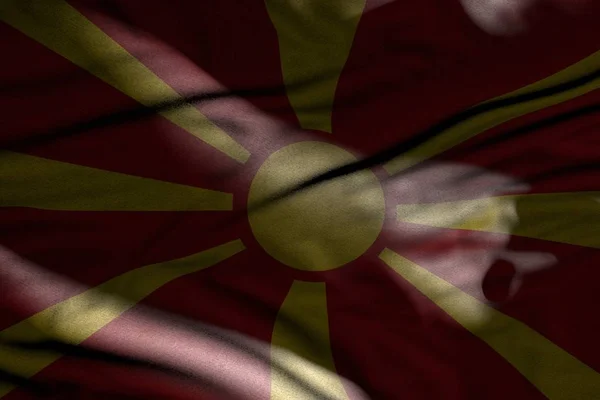 Fotografie frumoasă a steagului întunecat al Macedoniei cu pliuri întinse în umbre cu pete luminoase pe ea - orice ocazie pavilion ilustrație 3d — Fotografie, imagine de stoc