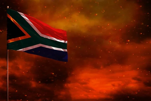 Fluttering South Africa flag mockup with blank space for your text on crimson red sky with smoke pillars background. Troubles concept. — ストック写真