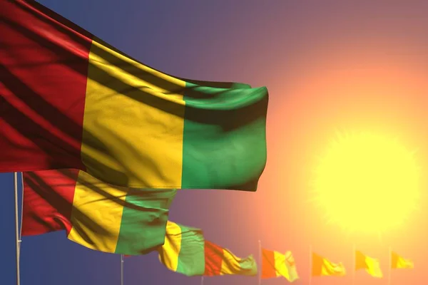 Досить багато прапорів Гвінеї на заході сонця розміщені діагональ з м'яким фокусом і місцем для вашого контенту - будь-який ілюстрація прапора 3d — стокове фото