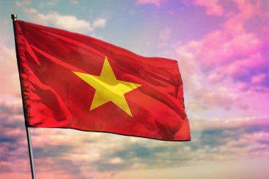 Fluttering Vietnam flag on colorful cloudy sky background. Vietnam prospering concept. clipart