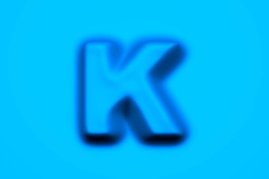 Mavi mum veya plastik alfabe - açık mavi arkaplan üzerinde K harfi izole edilmiş, sembollerin 3 boyutlu illüstrasyonu