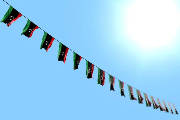 wonderful many Libya flags or banners hangs diagonal on rope on blue sky background with soft focus - any celebration flag 3d illustration