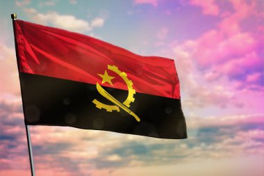 Renkli bulutlu arka planda dalgalanan Angola bayrağı. Angola refah konsepti.