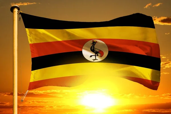 Uganda Flagge Webt Auf Dem Wunderschönen Orangefarbenen Hintergrund Des Sonnenuntergangs — Stockfoto