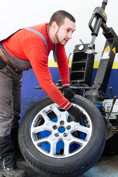 Mechanic removes car tire