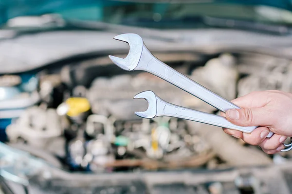 Hand of professional auto mechanic with wrench