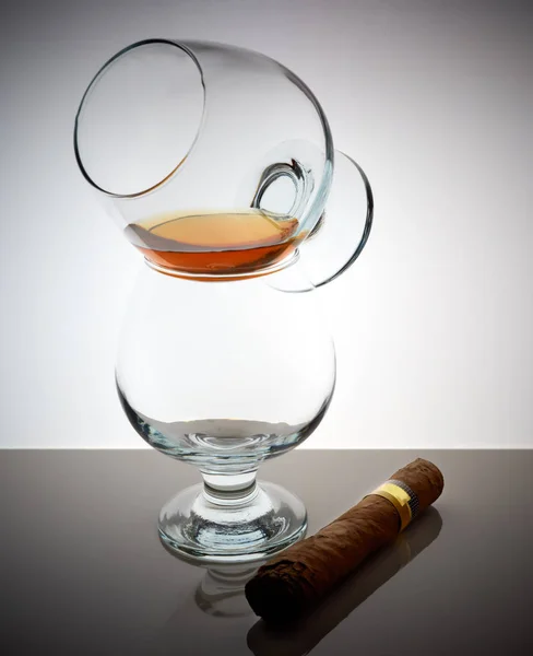 Glas whisky brandy cognac Cubaanse sigaar achtergrond licht verlopende glans — Stockfoto