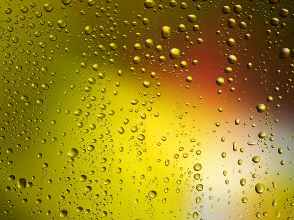 Vatten droppar färg bakgrunden regn glas utrymme rainbow. — Stockfoto